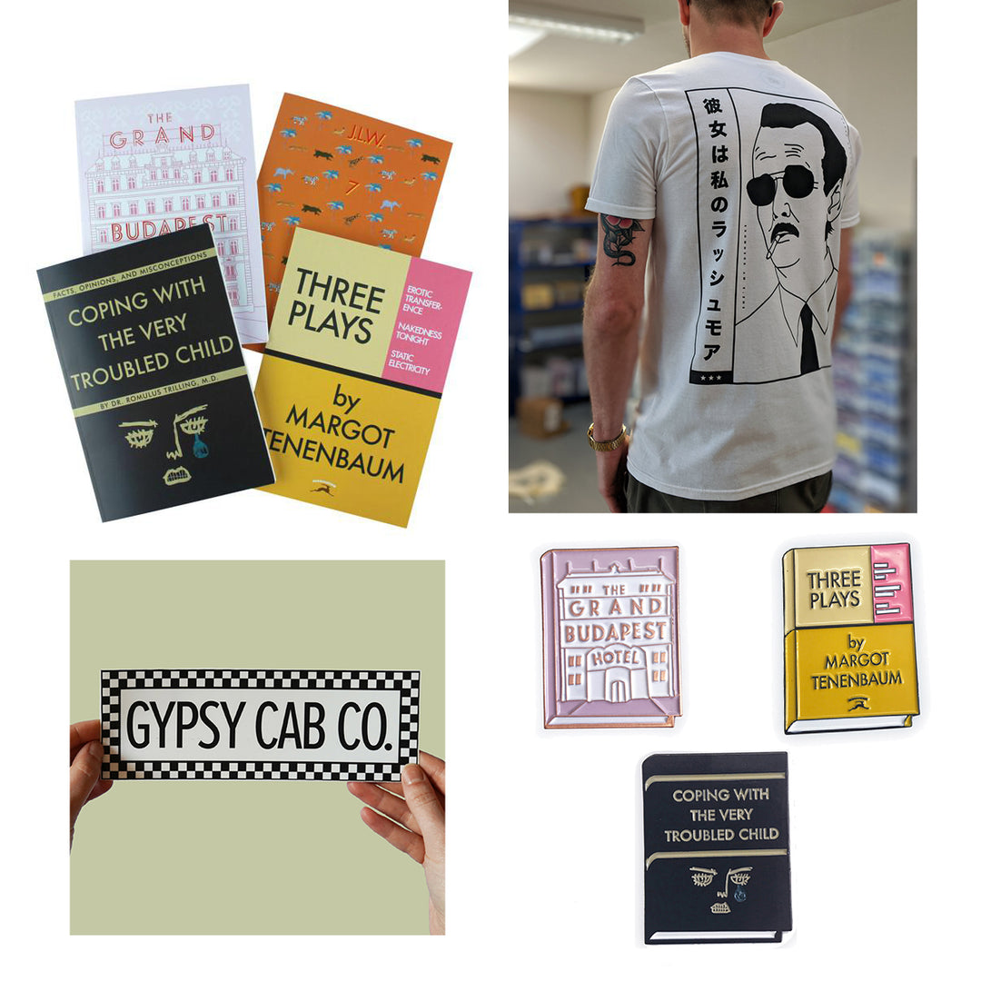 a collection of Wes Anderson Merch including, shirts, notebooks, stickers and enamel pins