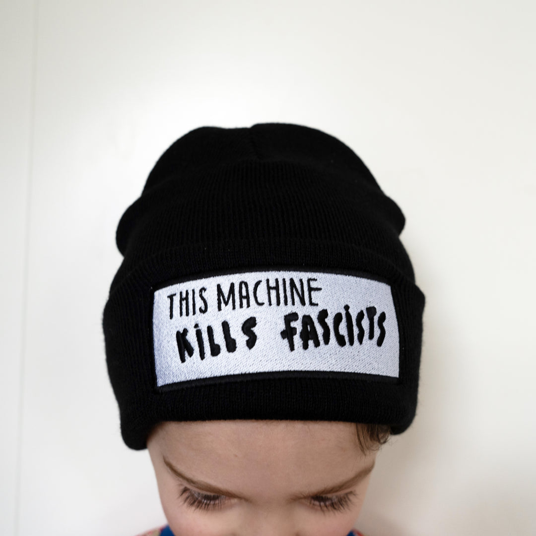 child wearing This Machine Kills Fascists Beanie 